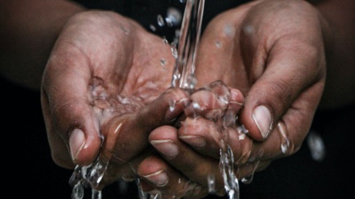 Water flows over hands